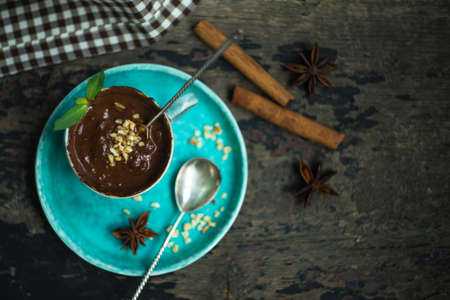 Cup of hot chocolate with nuts on dark wooden table with copyspaceの写真素材