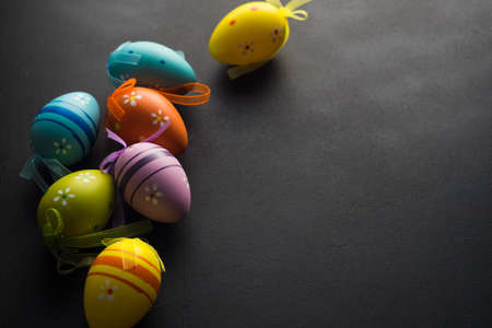 Easter holiday concept with colored easter eggs on wooden background with copyspace