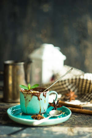 Cup of hot chocolate with nuts on dark wooden table with copyspaceの写真素材