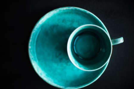 Empty ceramic coffee cup on dark wooden table with copyspaceの写真素材