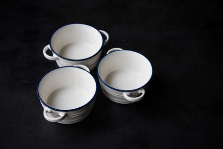 Empty ceramic tableware on dark wooden table