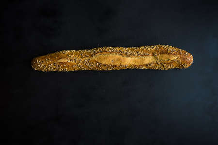 Healthy homemade bread with seeds on dark wooden background with copyspaceの写真素材