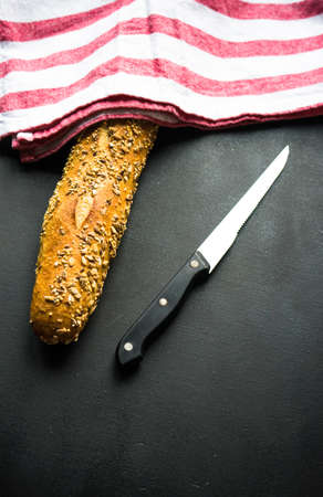 Healthy homemade bread with seeds on dark wooden background with copyspaceの写真素材