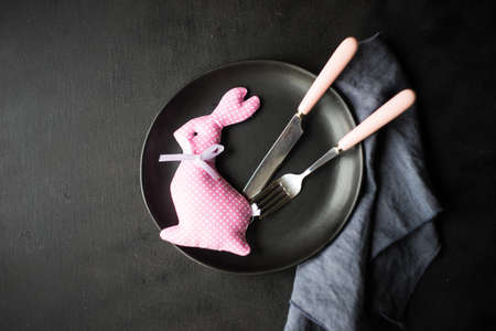 Festive table setting for holiday Easter dinner on dark wooden table with copyspaceの写真素材