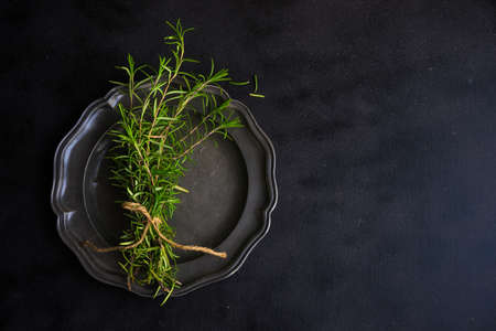 Fresh rosemary spice on rustic background as a cooking conceptの写真素材