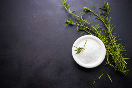 Spices and herbs in ceramic bowls on rustic wooden background with copyspaceの写真素材