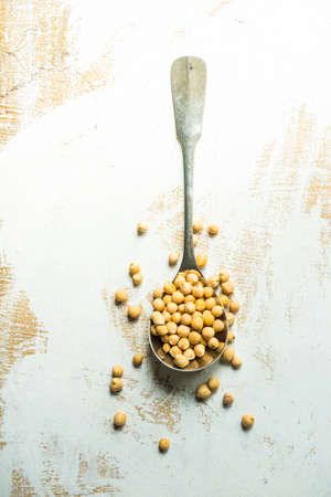 Organic food concept with raw chick peas on wooden backgroundの写真素材