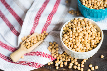 Organic food concept with raw chick peas on wooden background