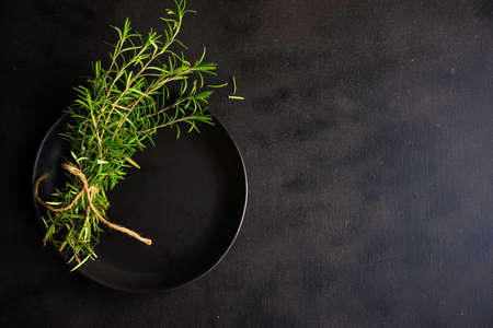 Fresh rosemary spice on rustic background as a cooking conceptの写真素材
