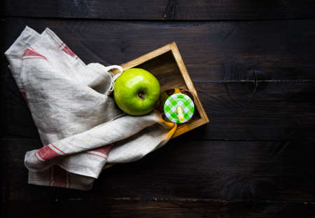 Wooden rustic box with vintage bottles of organic fruit juice on dark wooden table with copyspaceの写真素材