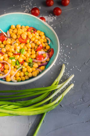 Homemade spicy vegetarian stew with chickpeas and vegetables on rustic wooden background with copy space. Organic food conceptの写真素材
