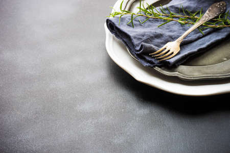 Summer time table setting with fresh rosemary spice on rustic background with copy spaceの写真素材