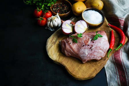 Ingredients for georgian meat dish - souzi, fresh pork meat, onion, garlic, potato, tomato and chilli pepperの写真素材