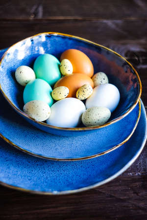 Table setting for holiday Easter dinner on dark wooden table with copy spaceの写真素材