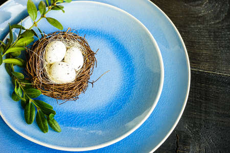 Table setting for holiday Easter dinner on dark wooden table with copy spaceの写真素材