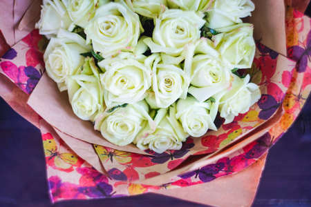 Beautiful bouquet with fresh white roses on a table with copyspaceの写真素材