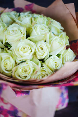 Beautiful bouquet with fresh white roses on a table with copyspaceの写真素材
