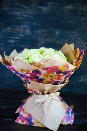 Beautiful bouquet with fresh white roses on a table with copyspaceの写真素材