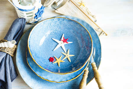 Summertime table setting in marine style on white rustic tableの写真素材