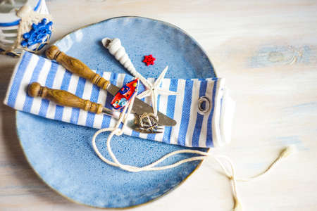 Summertime table setting in marine style on white rustic tableの写真素材