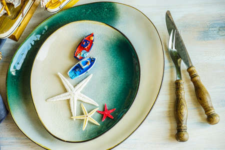 Summertime table setting in marine style on white rustic tableの写真素材