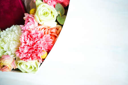 Heart shaped gift box full of anemone flowers on dark background with copy spaceの写真素材