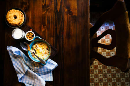 Rustic georgian breakfast set with healthy corn and milk porridge  on dark wooden tableの写真素材