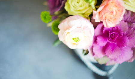 Summer flowers in gift box on dark wooden backgroundの写真素材