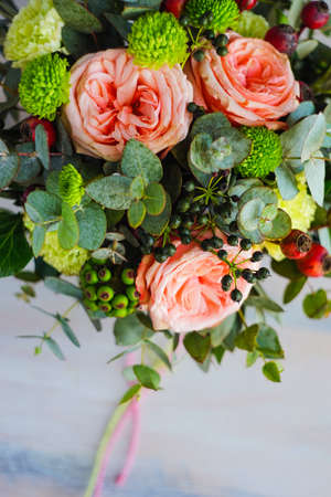 Summer flowers in gift box on dark wooden background