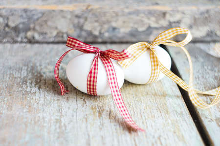 Easter holiday concept with eggs wrapped with ribbonの写真素材