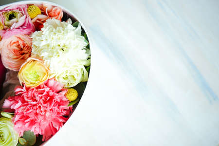 Heart shaped gift box full of anemone flowers on dark background with copy spaceの写真素材