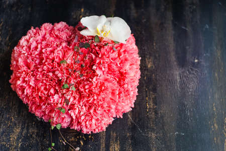 Creative card concept with beautiful flowers on wooden background with copyspaceの写真素材