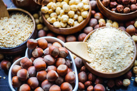 Different types of hazelnuts on dark wooden background with copyspaceの写真素材