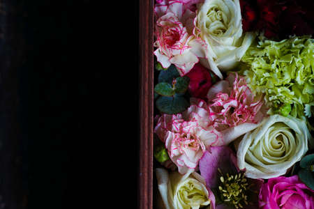 Creative card concept with beautiful flowers on wooden background with copyspace