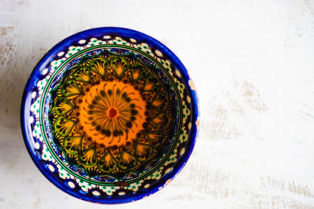 Traditional uzbekistan ornament on bowl with tea as a tea conceptの写真素材