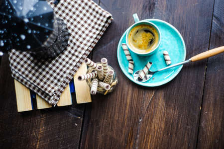 Cup of coffee, coffee pot and sweets on rustic table with copyspaceの写真素材