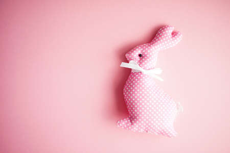 Easter holiday card with easter bunny on bright pink  background with copy spaceの写真素材