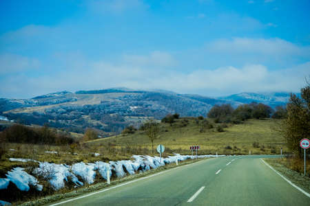 Winter road in Caucasus mountain with snow on the top of mountain and borders of a road, Georgia