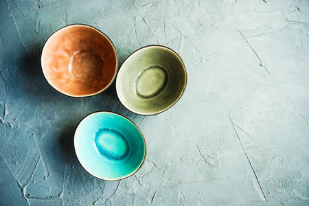 Rustic ceramic bowls on grey concrete background with copyspaceの写真素材