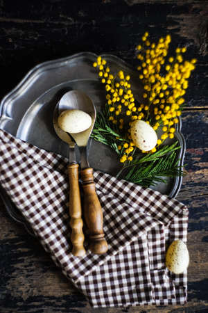 Spring table setting with bright yellow mimosa flowersの写真素材