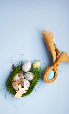 Easter holiday card with colored eggs on pastel blue backgroundの写真素材