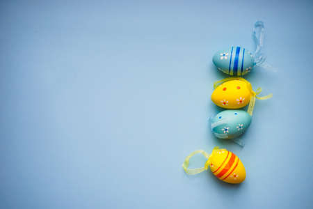 Easter holiday card with colored eggs on pastel blue background