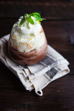 Tasty chocolate milkshake decorated with fresh mint