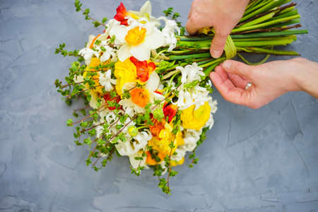 Summer bouquet with bright yellow and white flowers on rustic background with copyspaceの写真素材