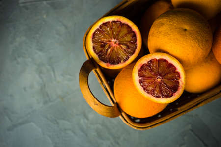 Vintage box full of organic red blood oranges on natural background with copyspaceの写真素材