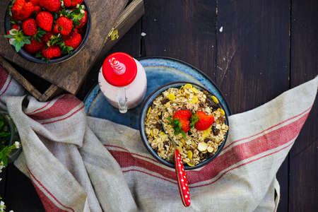 Summer breakfast with oatmeals and fres organic strawberries on rustic wooden tableの写真素材