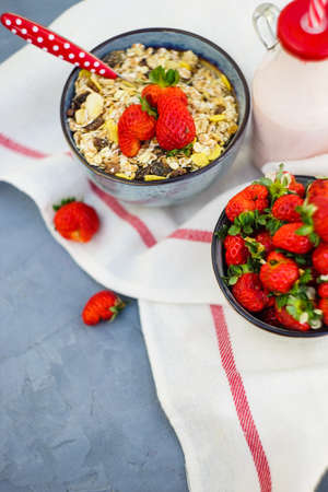 Summer breakfast with oatmeals and fres organic strawberries on rustic wooden tableの写真素材