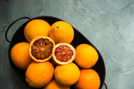 Vintage box full of organic red blood oranges on natural background with copyspaceの写真素材