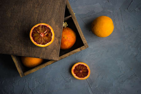 Vintage box full of organic red blood oranges on natural background with copyspaceの写真素材