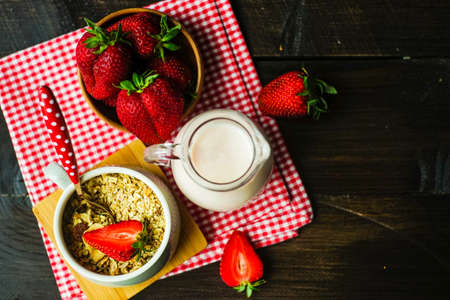 Healthy breakfast with oatmeals with organic strawberries on rustic background with copy spaceの写真素材